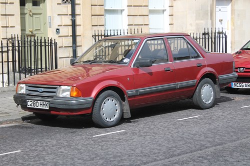 red Ford Orion parked on a road