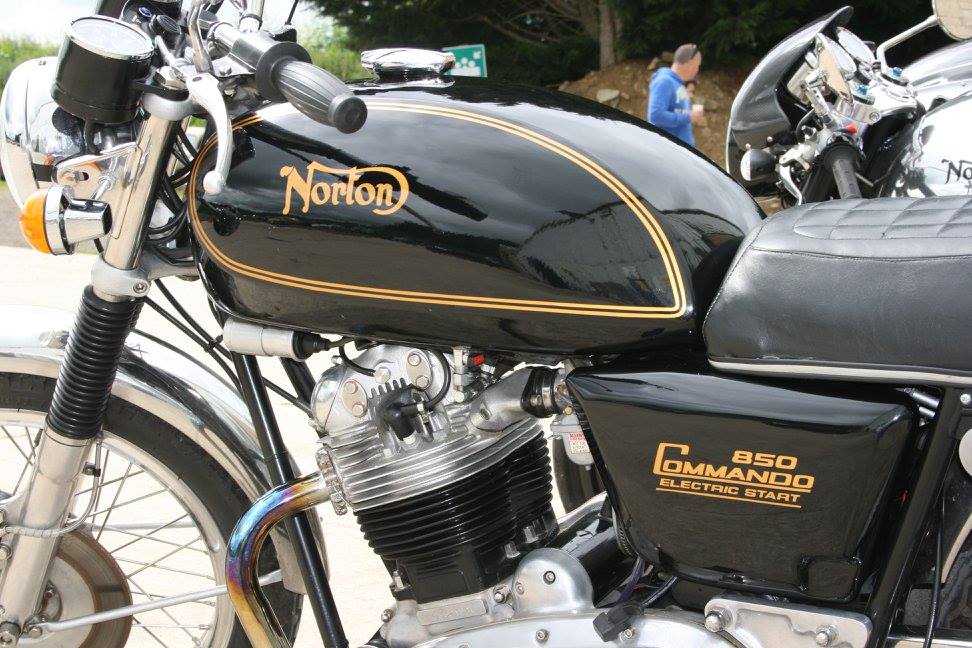 Side of black classic bike with gold decals