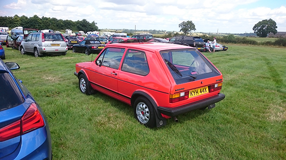 Red Mk1 Golf GTI parked on grass