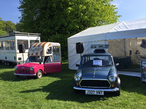 Man with dog standing next to Classic Mini