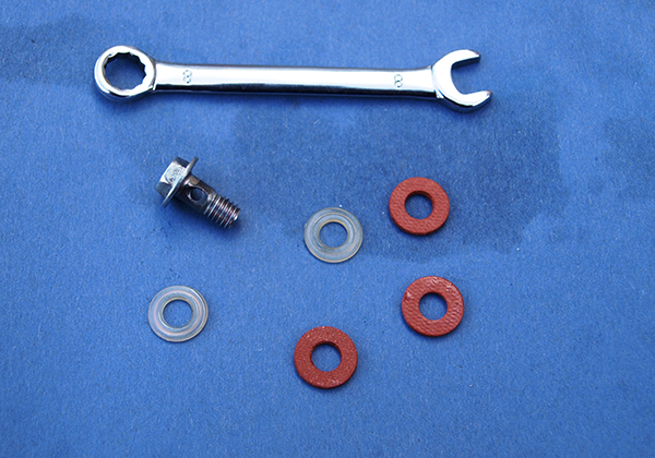 Washers, screw and spanner sitting on blue sheet