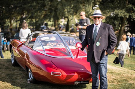 Man standing next to a classic car