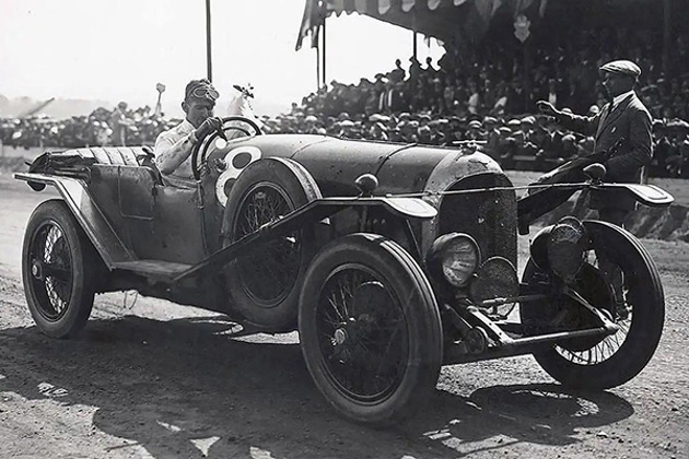 john-duff-1924-stationary-in-a-racing-car-on-a-race-track