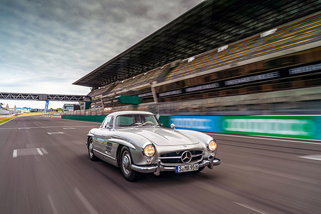 silver-mercedes-benz-300sl-gullwing-racing-on-a-track