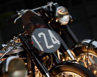close-up-of-round-number-plate-on-the-handle-bars-of-a-vintage-bike.jpg