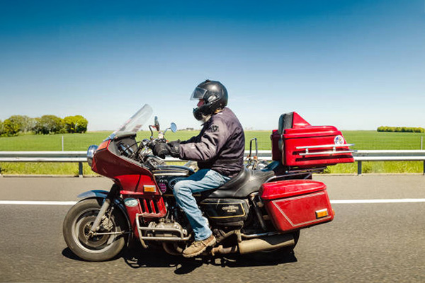 Red 1974 to 1979 Honda GL1000 Goldwing being ridden
