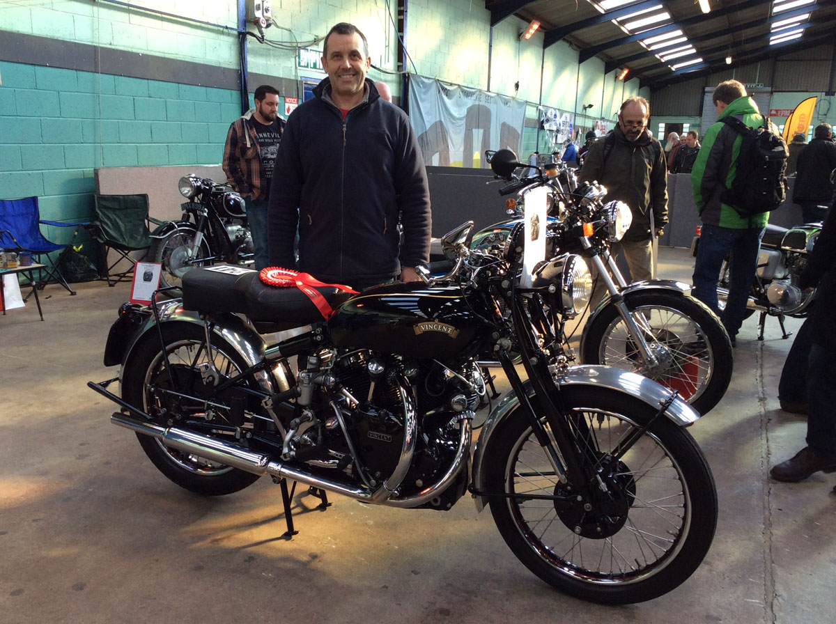 Man stands with winning motorcycle