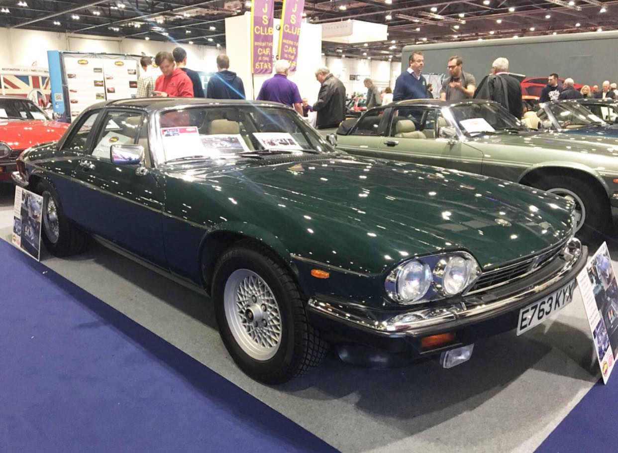 Green classic car sitting on podium