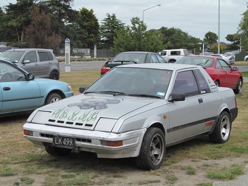 Grey Nissan Pulsar EXA parked on grass