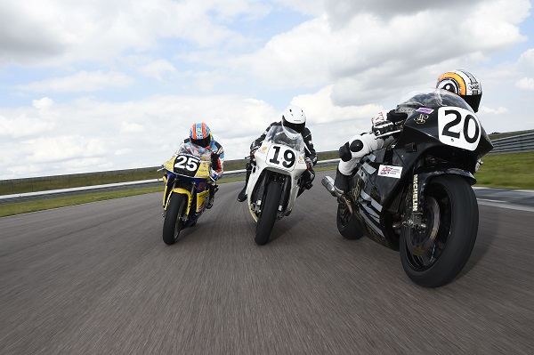 Three motorcycles racing on race track