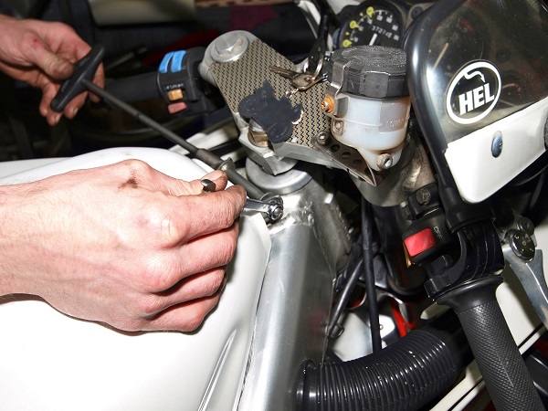 Man unbolting fixings on a bike