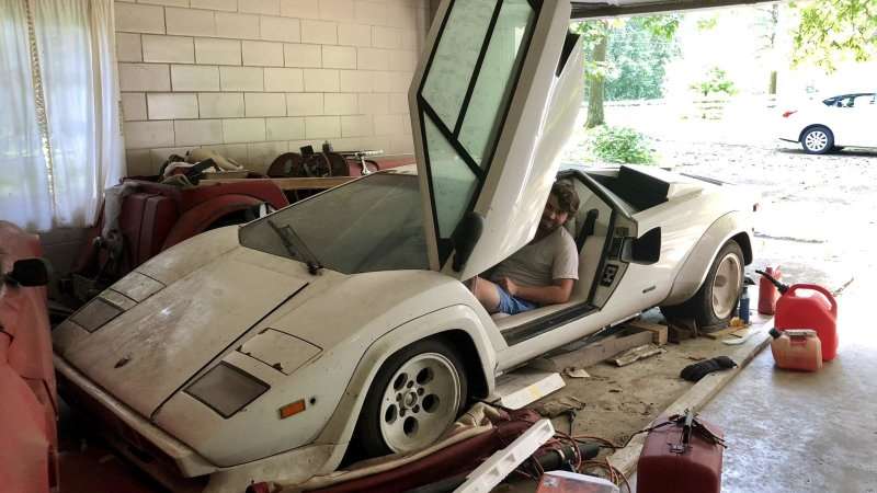 Man sitting in a Lamborghini Countach in a garage