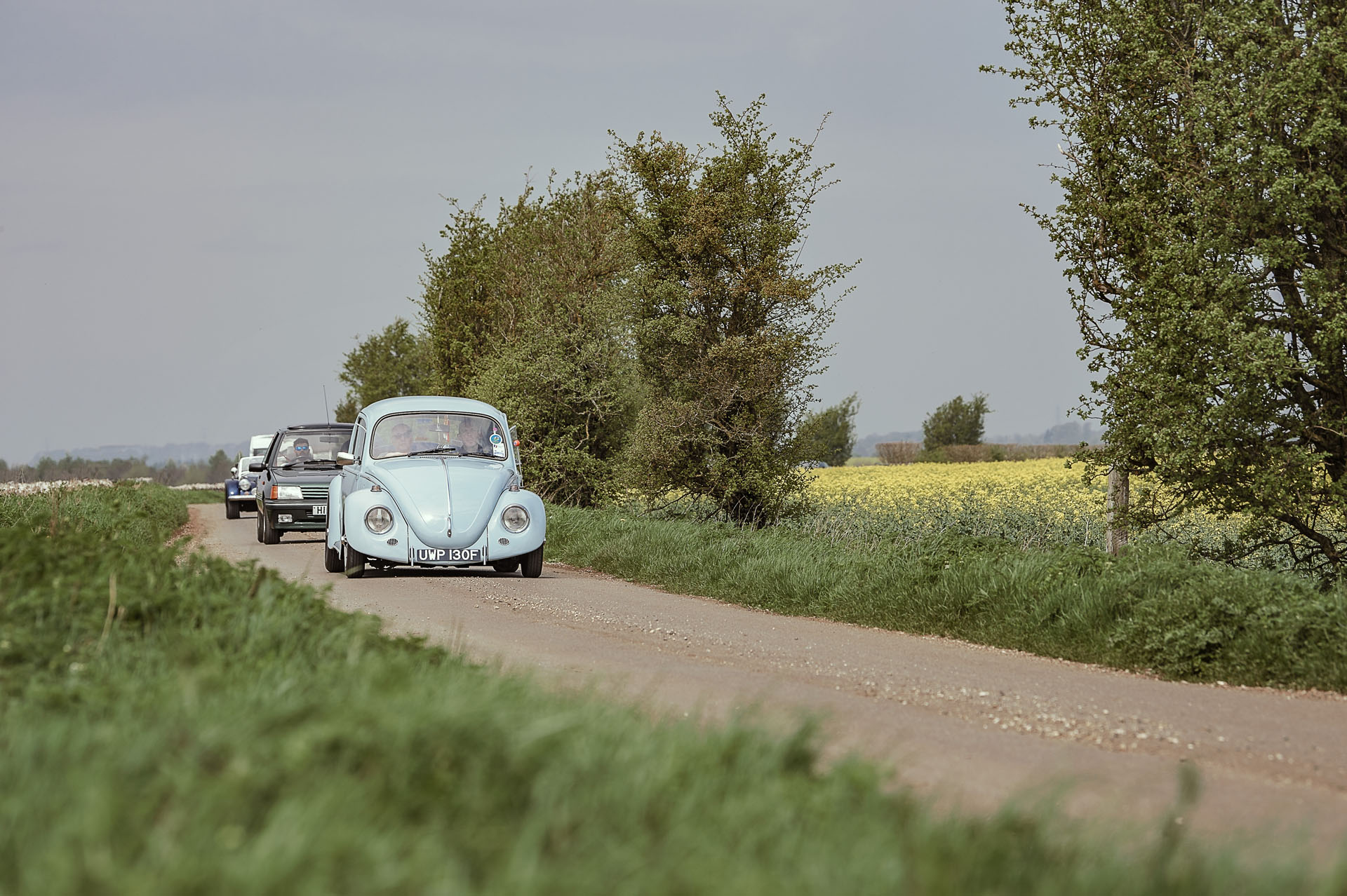 Classic convoy led by blue Volkswagen