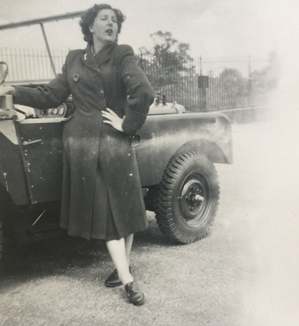 Dorothy posing next to car