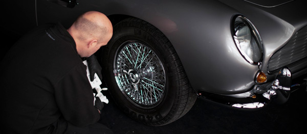 CMC cleaning the wheels of an Aston Martin DB5