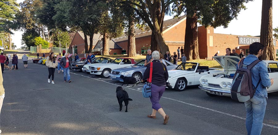 Enthusiasts browse the cars on display