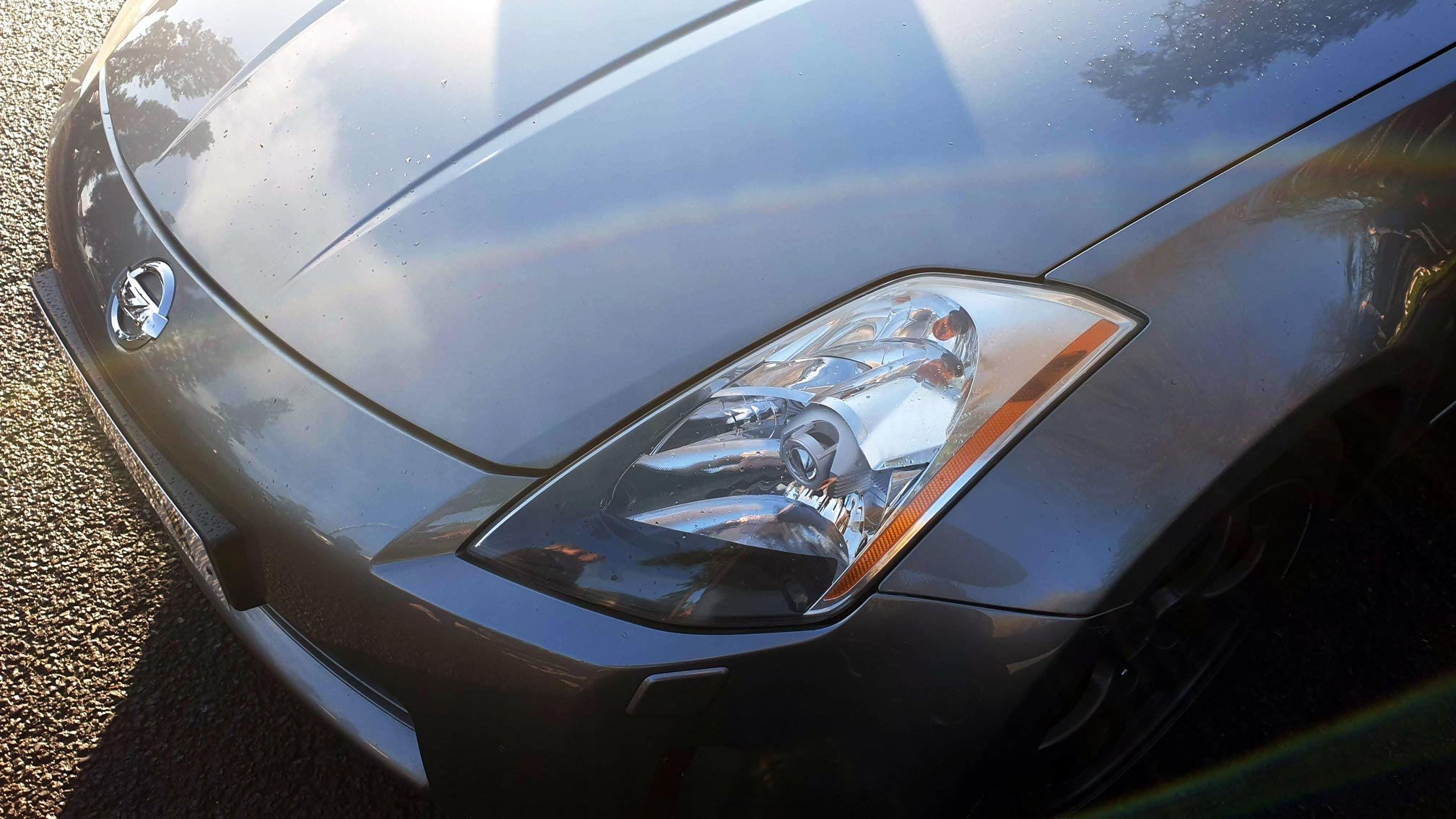 Dark silver Nissan with hood and headlights