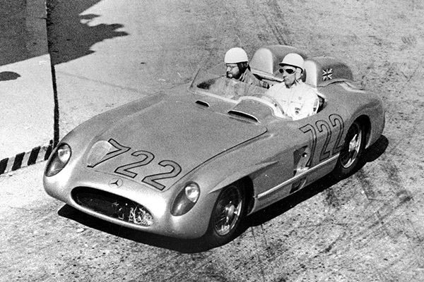Black and white image of a Mercedes Benz at Mille Miglia with two men in the car