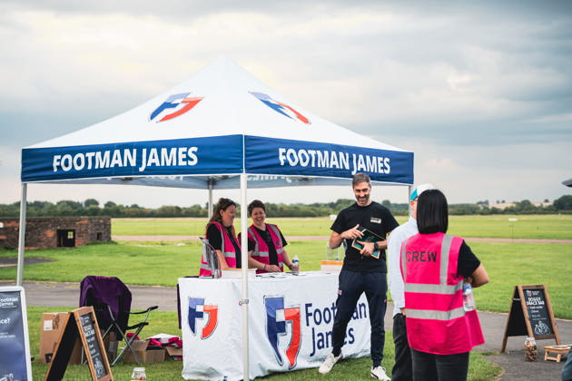 A Footman James stand at an event