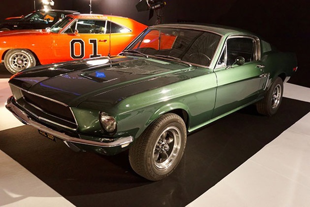 A green Mustang in a showroom