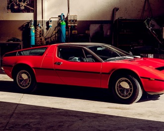 A red Maserati Bora in a workshop