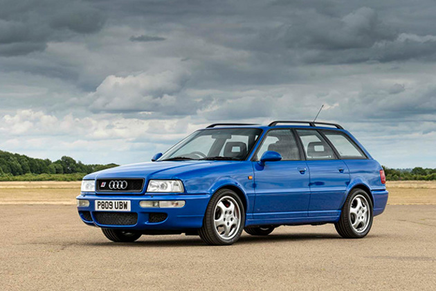 front-view-blue-audi-rs2-avant-stationary-with-fields-and-trees-backdrop
