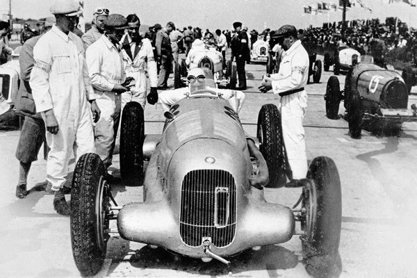 Don Alfredo In A Mercedes Benz W25 Surrounded By Men In Boiler Suits