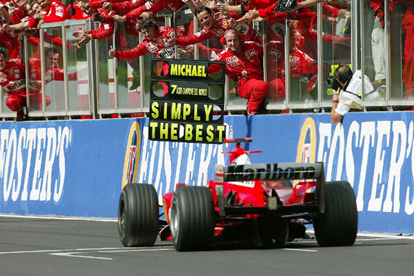 2004 Michael Schumacher driving a red Ferrari F2004 at Francorchamps