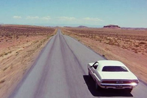 White 1970 Dodge Challenger RT Driving In The South Western USA Desert in the film Vanishing Point