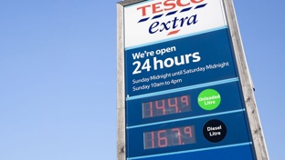 A Tesco petrol sign against a blue sky