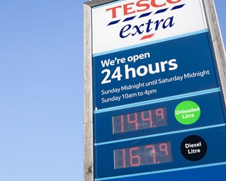 A Tesco petrol sign against a blue sky