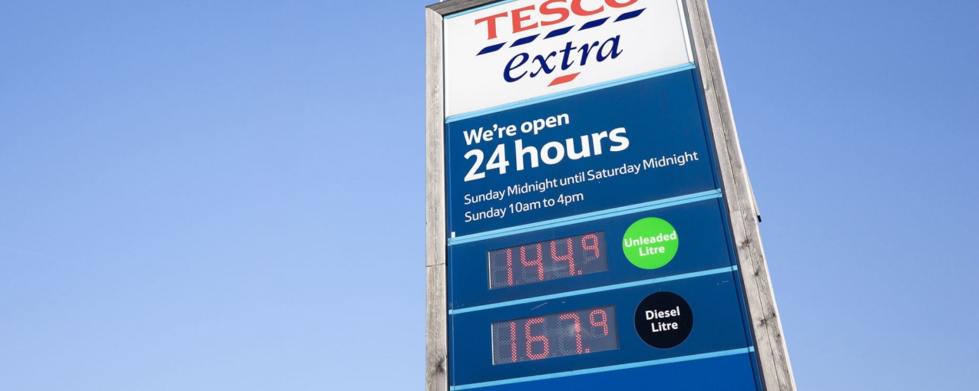 A Tesco petrol sign against a blue sky