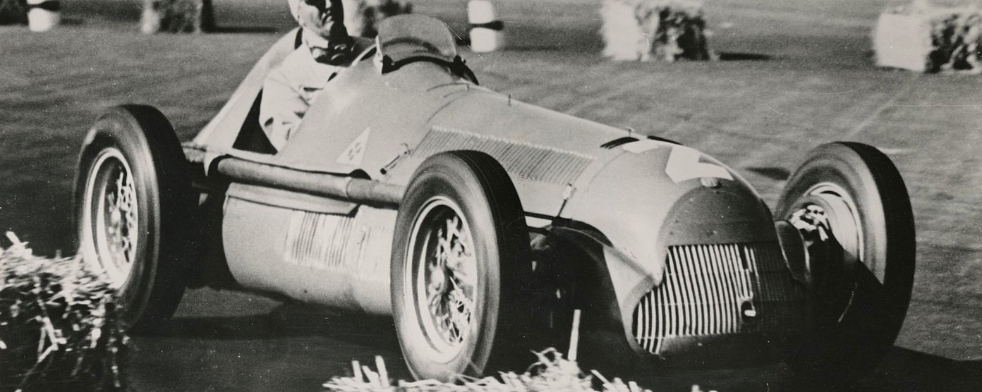 Racing driver in an Alfa Romeo Grand Prix car.