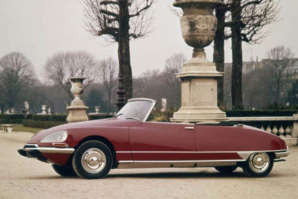 Red 1969 Citroen Ds Chapron Majesty Convertible with stately home style garden backdrop