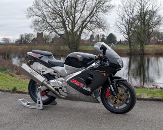 Aprilia RSV 1000 Mille parked in front of a lake