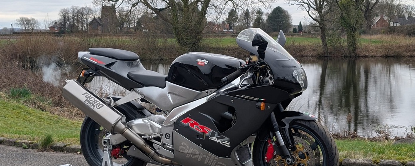 Aprilia RSV 1000 Mille parked in front of a lake