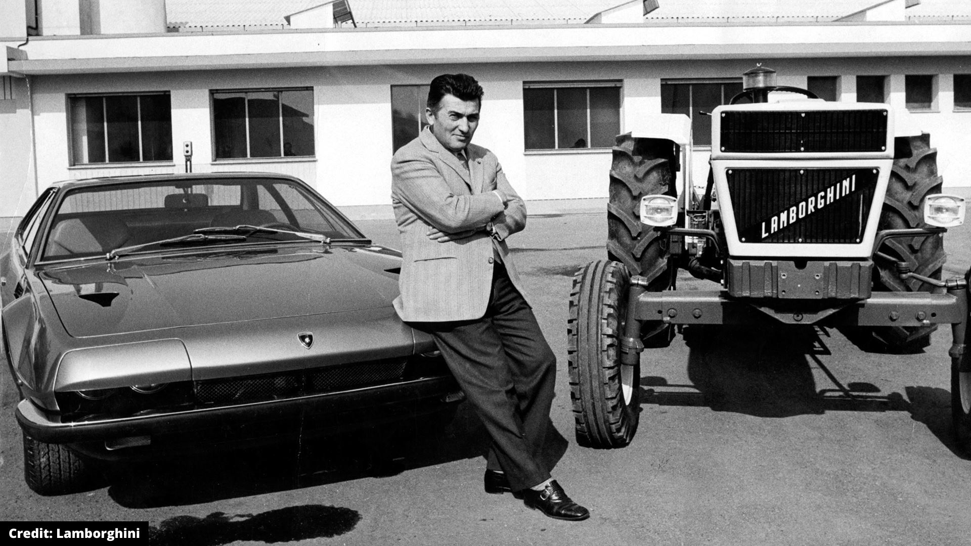 Man standing by Lamborghini car and tractor