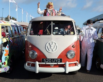 Three VW camper vans in a row at a festival