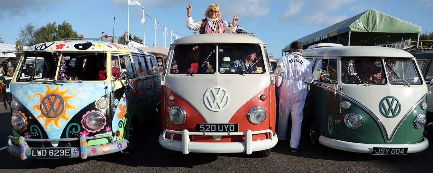 Three VW camper vans in a row at a festival