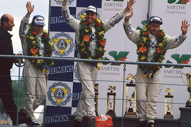 1st-podium-lehto-dalmas-and-sekiya-waving-wearing-neck-garlands