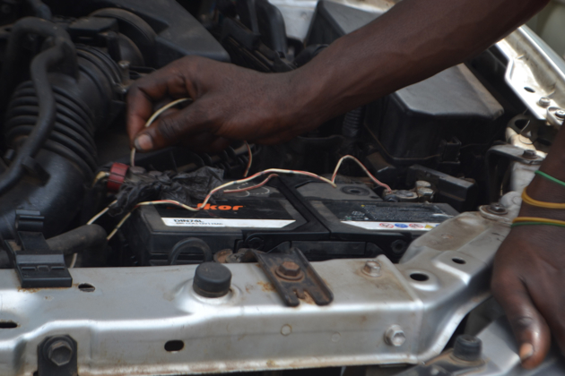 A close up of a hand checking a car engine