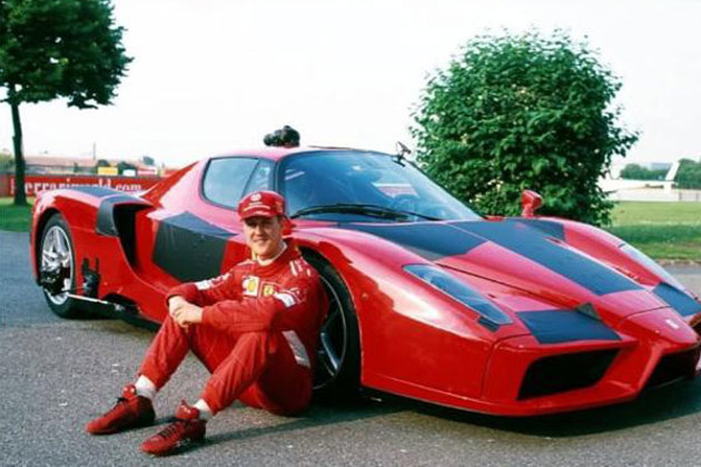 michael-schumacher-sitting-beside-a-2002-04-red-ferrari-enzo
