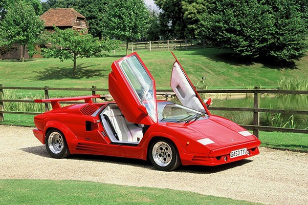 A red Lamborghini Countach with the doors elevated