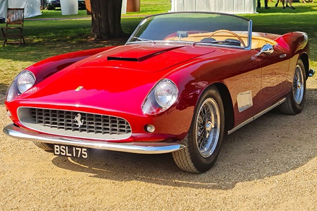 A red Ferrari with the sun shining on it 