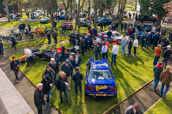 Subaru Impreza Oracle Red Bull Rb20 Formula One Car Team Vodafone Amg Mercedes On Grass With Other Cars And Motor Bikes And People Walking Among Them