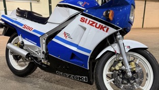 A blue and white Suzuki 500