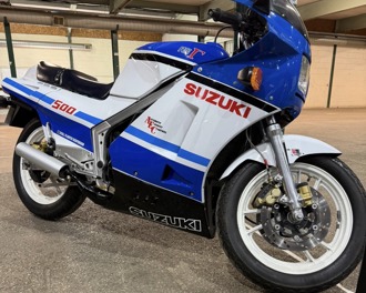 A blue and white Suzuki 500