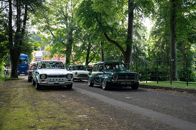 white-ford-escort-mini-clubman-1275-gt-on-tree-lined-road