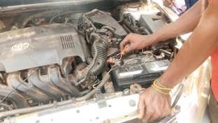 A car battery exposed by an open bonnet