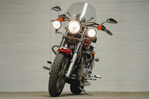 Front view of a Triumph Bonneville America with headlamps on